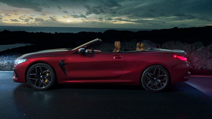 BMW M8 Competition Cabrio, külgvaade. BMW M8 Competition Cabrio toonis Motegi Red metallik, avatud pehme katusega, külgvaade, seismas tähistaeva all.