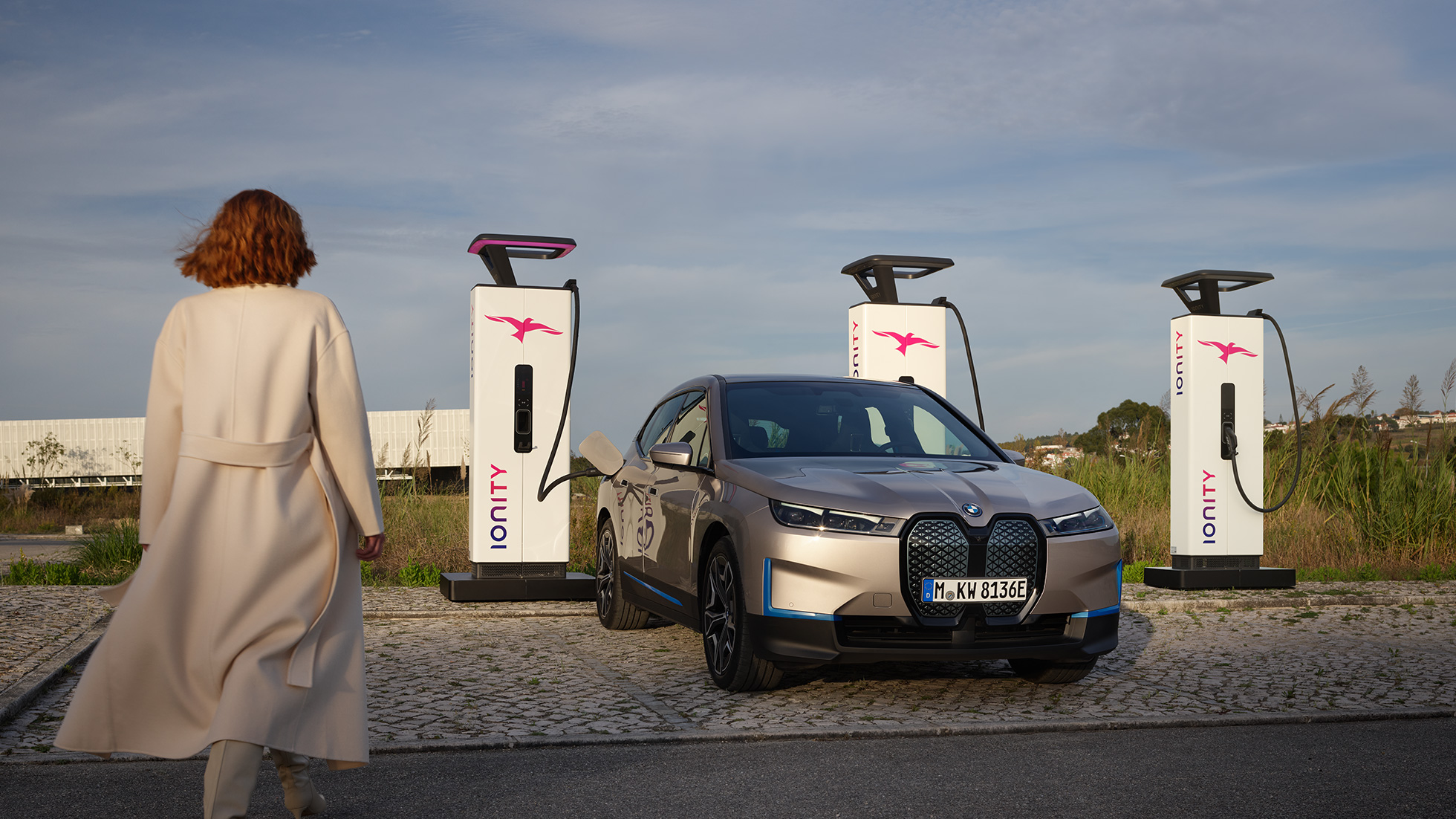 BMW iX kolm neljandikku eestvaade laadimisjaamas BMW iX Cashmere Silver i20 kolm neljandikku eestvaade laadimisjaamas