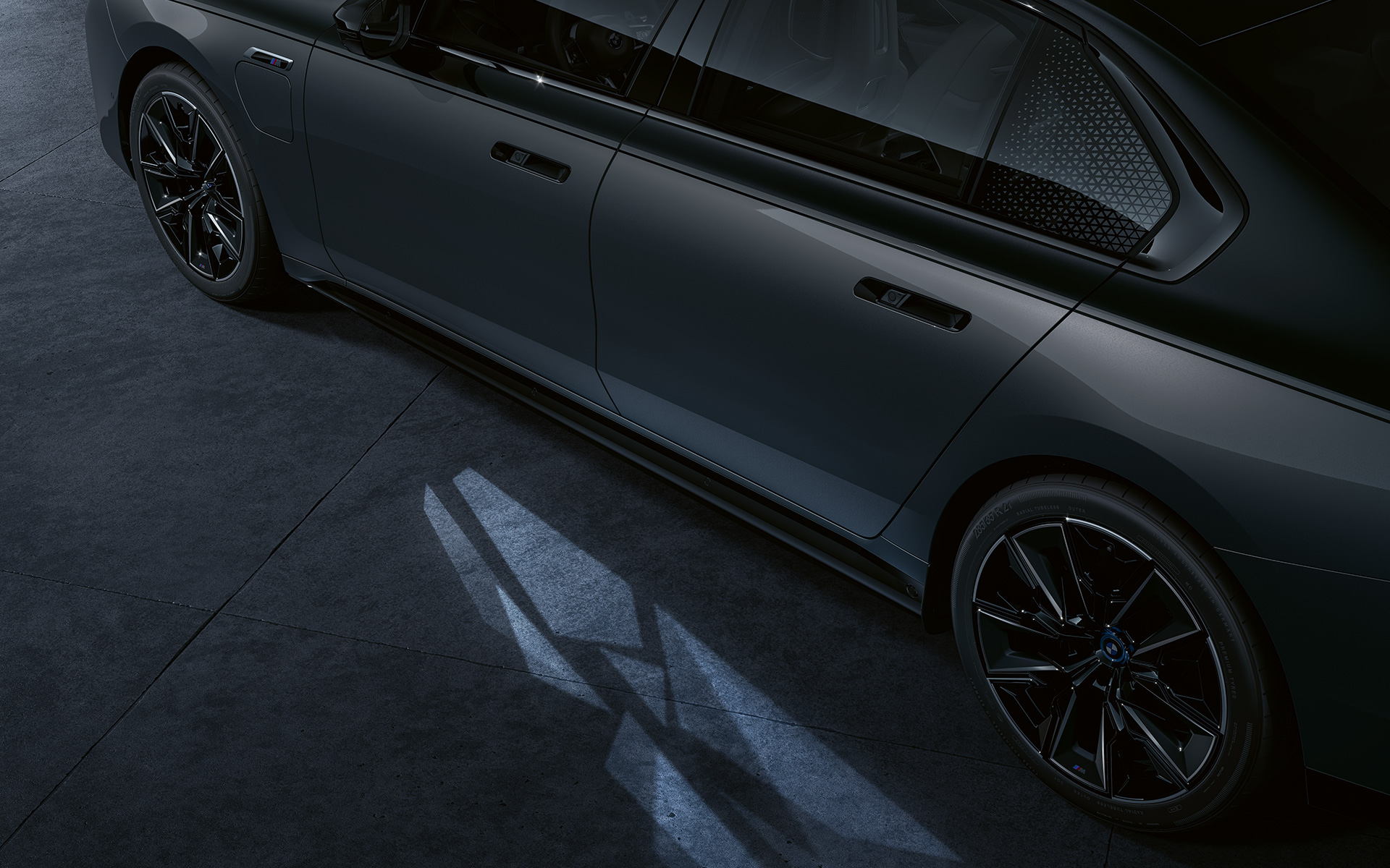 Valgustuskontseptsioon, BMW M760e xDrive Sedaan G70, BMW Individuali kahetooniline värviviimistlus Black Sapphire metallik, BMW Individual Dravite Grey metallik, külgvaade, lähivõte, tervitav valgusvaip sisse lülitatud