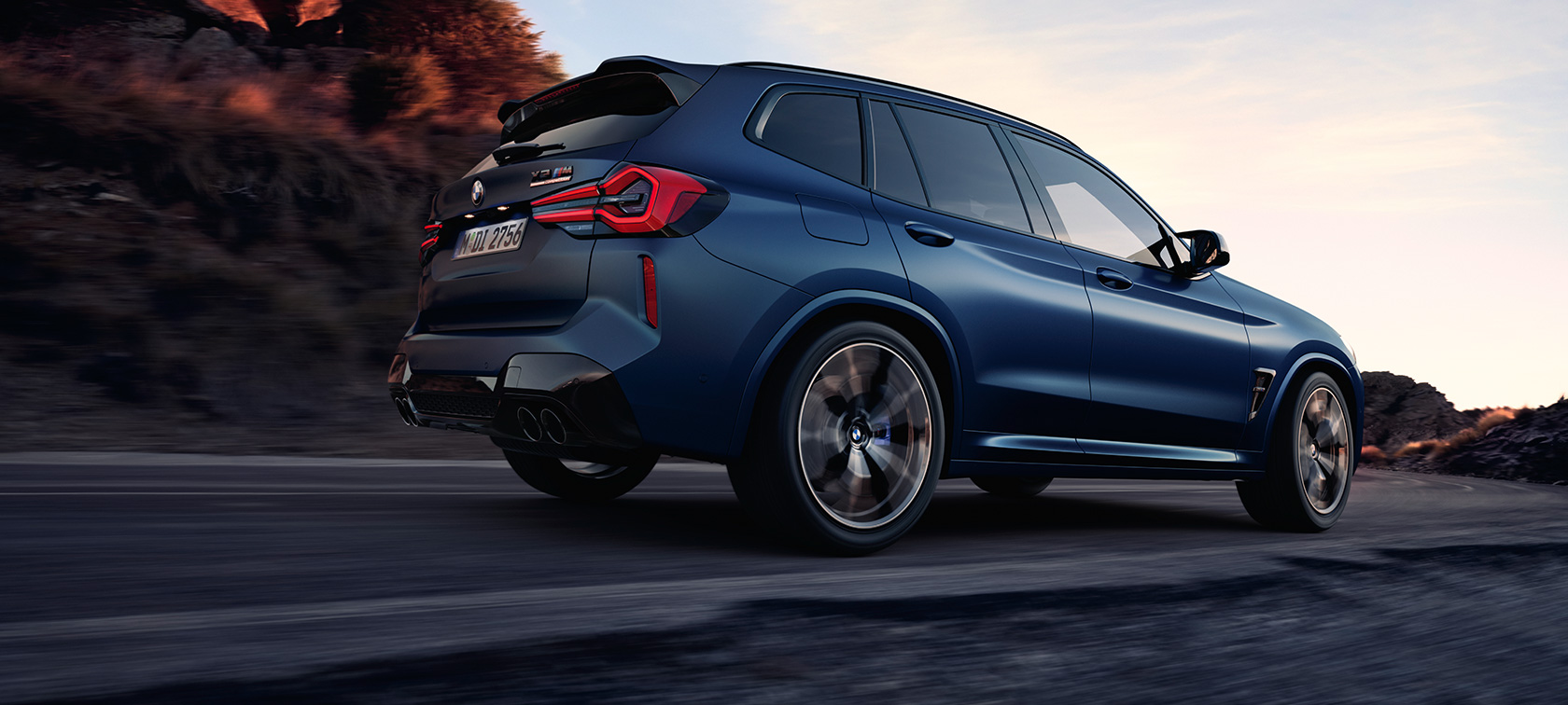 BMW X3 M Competition F97 LCI 2021, kolm neljandikku tagantvaade, madal võttenurk BMW X3 M Competition F97 LCI Facelift 2021, toonis Frozen Marina Bay Blue metallik, kolm neljandikku tagantvaade sõitmas, madal võttenurk