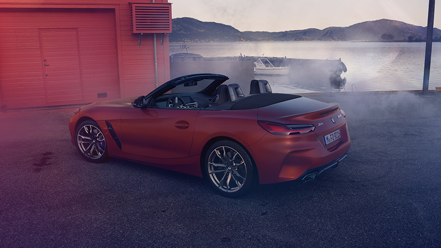 Driving BMW Z4 First Edition Driving BMW Z4 First Edition in rear view on mountain street