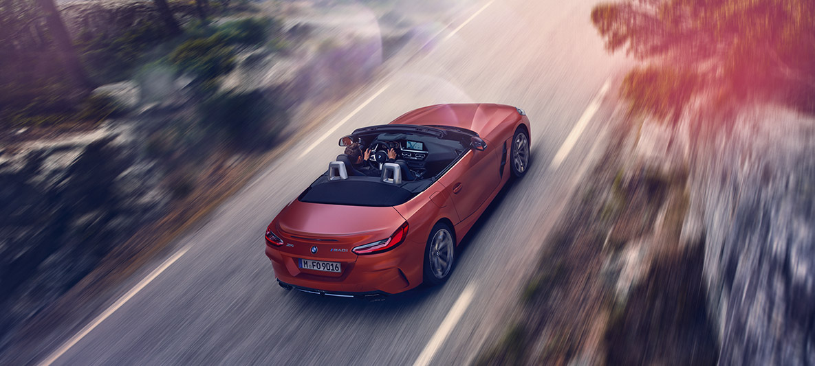 Orange BMW Z4 First Edition driving Orange BMW Z4 First Edition driving from bird’s eye view